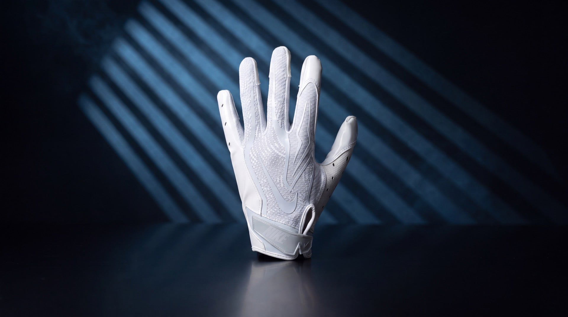 White Nike football receiver glove in cold blue striped studio light, cover for the best football gloves guide