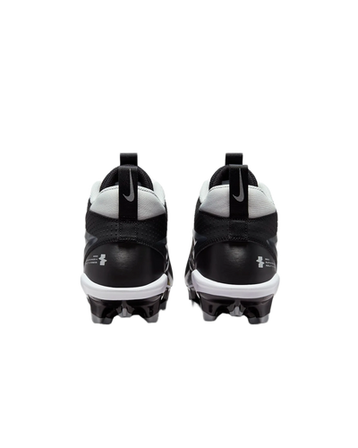 Rear view of black and white Nike Alpha Menace Varsity 4 cleats with cleated soles for football.